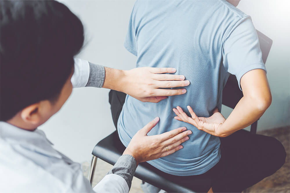 Chiropractor assesing patient